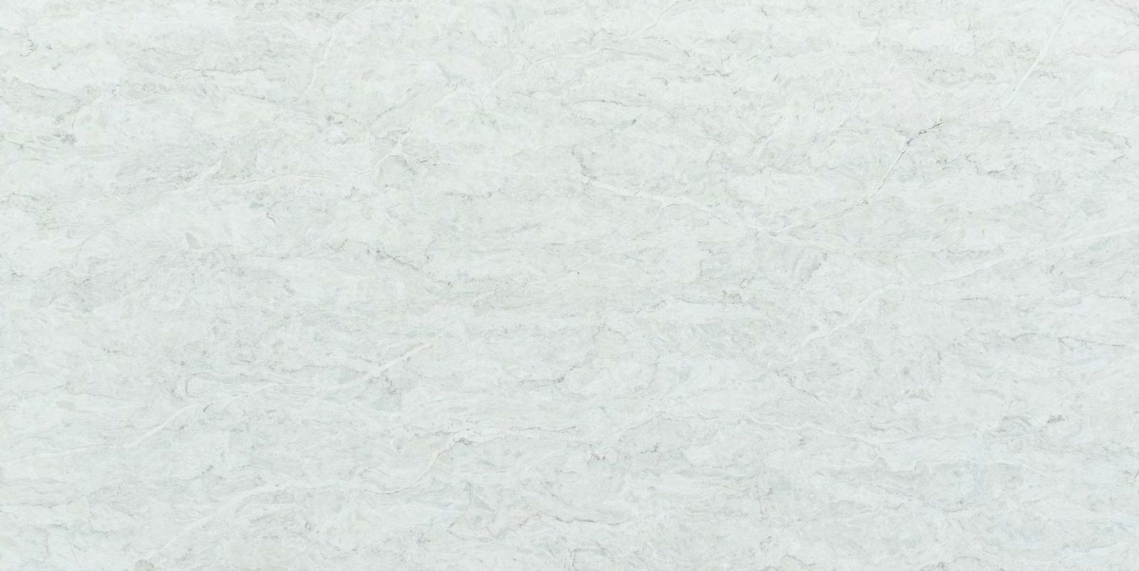 Close-up of a pale cool-white quartz surface showing the fine grain