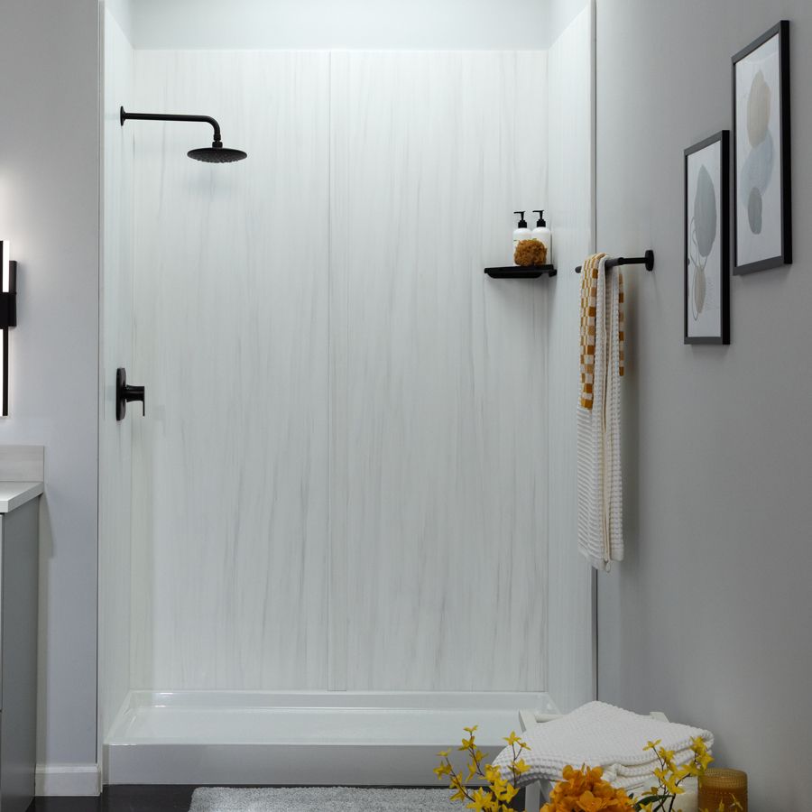Low-barrier shower with stone-look walls and a built-in seat